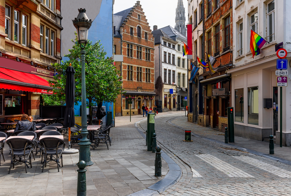 Old street with tables of cafe in center of Brussels, Belgium. Cozy cityscape of Brussels (Bruxelles). Architecture and landmarks of Brussels.