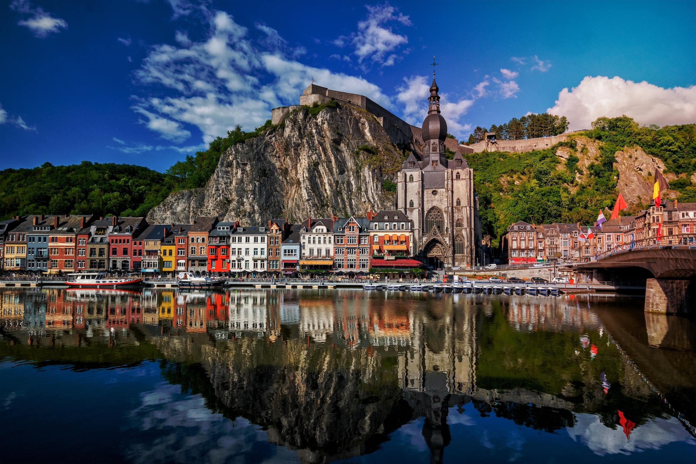 TOP 15 najpiękniejszych miast i miasteczek w Belgii Widok na malownicze miasto Dinant, cytadelę Dinant i kolegiatę Notre Dame de Dinant oraz most Pont Charles de Gaulle nad rzeką Mozą. Belgijska prowincja Namur, Belgia