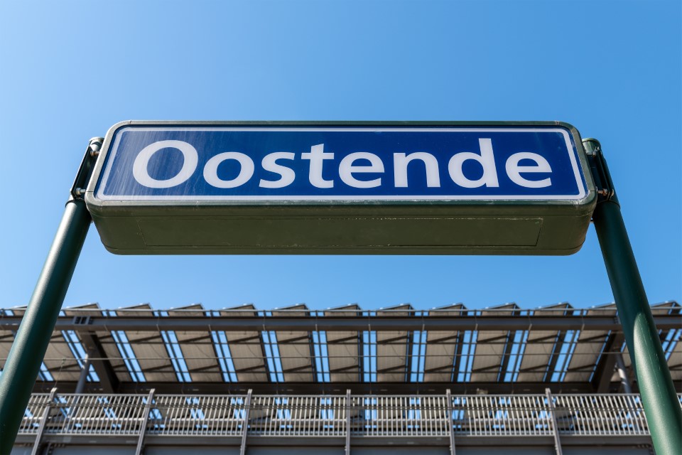 Name board of Oostende city on platform in Ostend railway train station, Belgium.